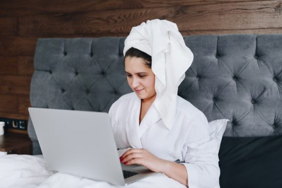 woman working romotely in her bath robe